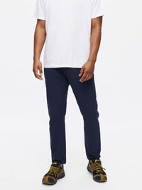 Model standing in Zephyr Pant in Navy, featuring a custom-fit drawstring waist and zippered pockets.