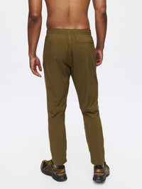 Back view of Zephyr Pant in Olive, featuring a custom-fit drawstring waist and zippered pockets.
