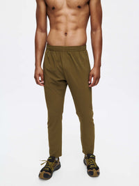Model wearing Zephyr Pant in Olive Green, featuring a custom-fit drawstring waist for medium to high-sweat activities.