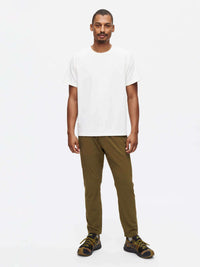 Model standing in Zephyr Pant in Olive, featuring zippered pockets and a drawstring waist for easy adjustment.